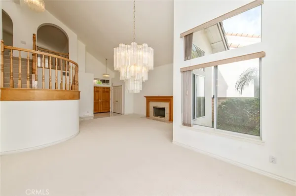 a view of livingroom with furniture chandelier and front door