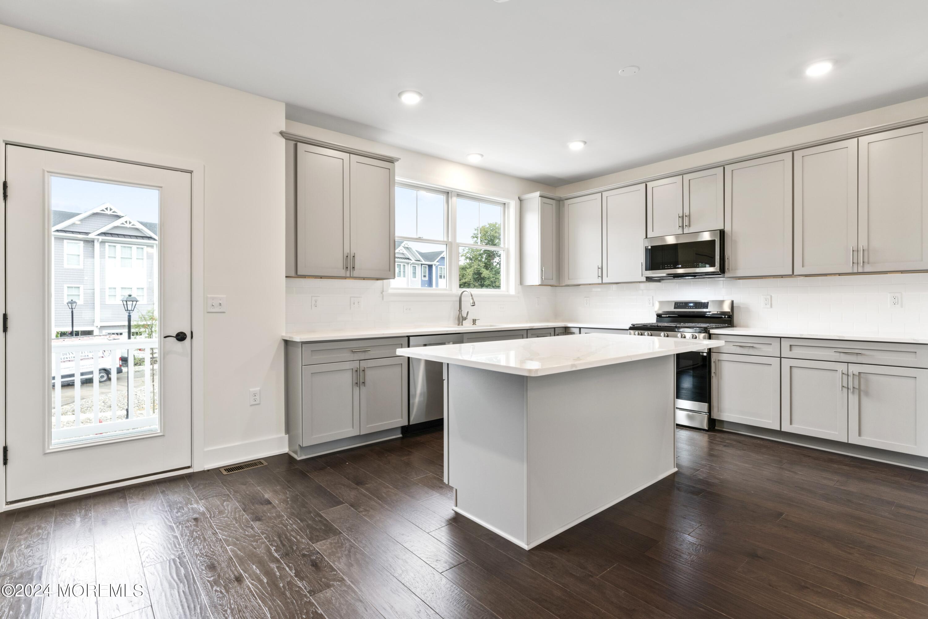 25 Raritan Cove Keyport, NJ 07735 - Photo 14 of 50 a kitchen with granite countertop white cabinets and white appliances