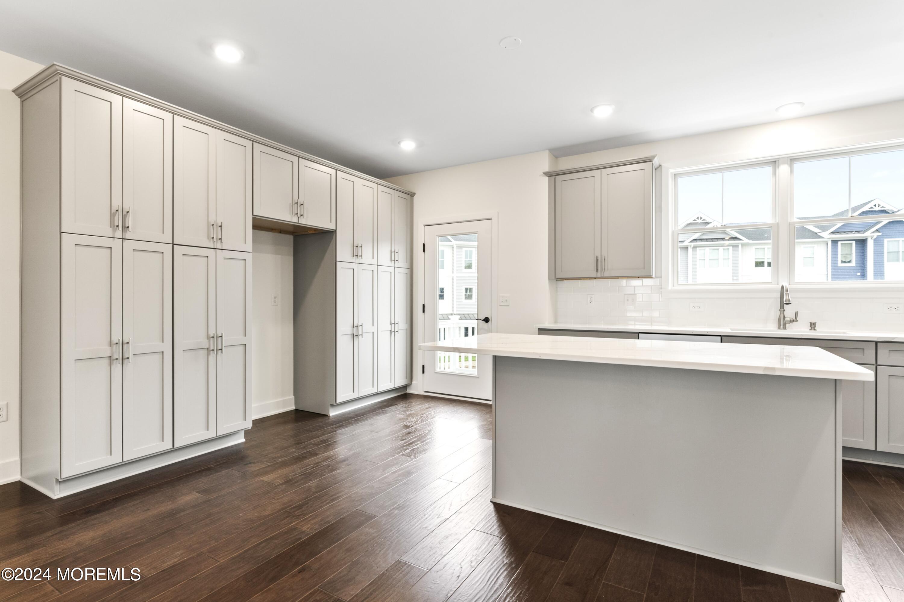 25 Raritan Cove Keyport, NJ 07735 - Photo 15 of 50 a kitchen with stainless steel appliances granite countertop a refrigerator a sink and white cabinets with wooden floor