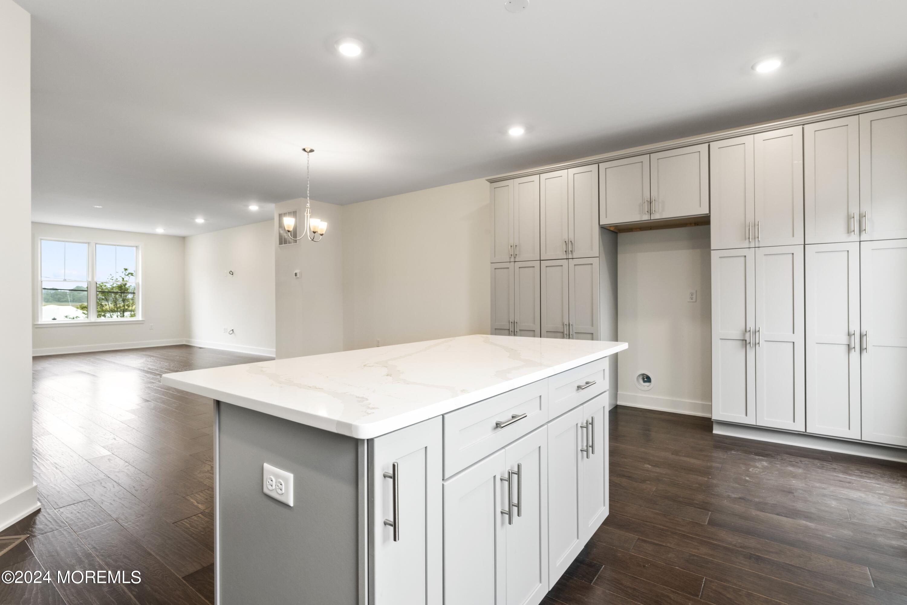 25 Raritan Cove Keyport, NJ 07735 - Photo 18 of 50 a kitchen with a stove a refrigerator a sink and white cabinets with wooden floor