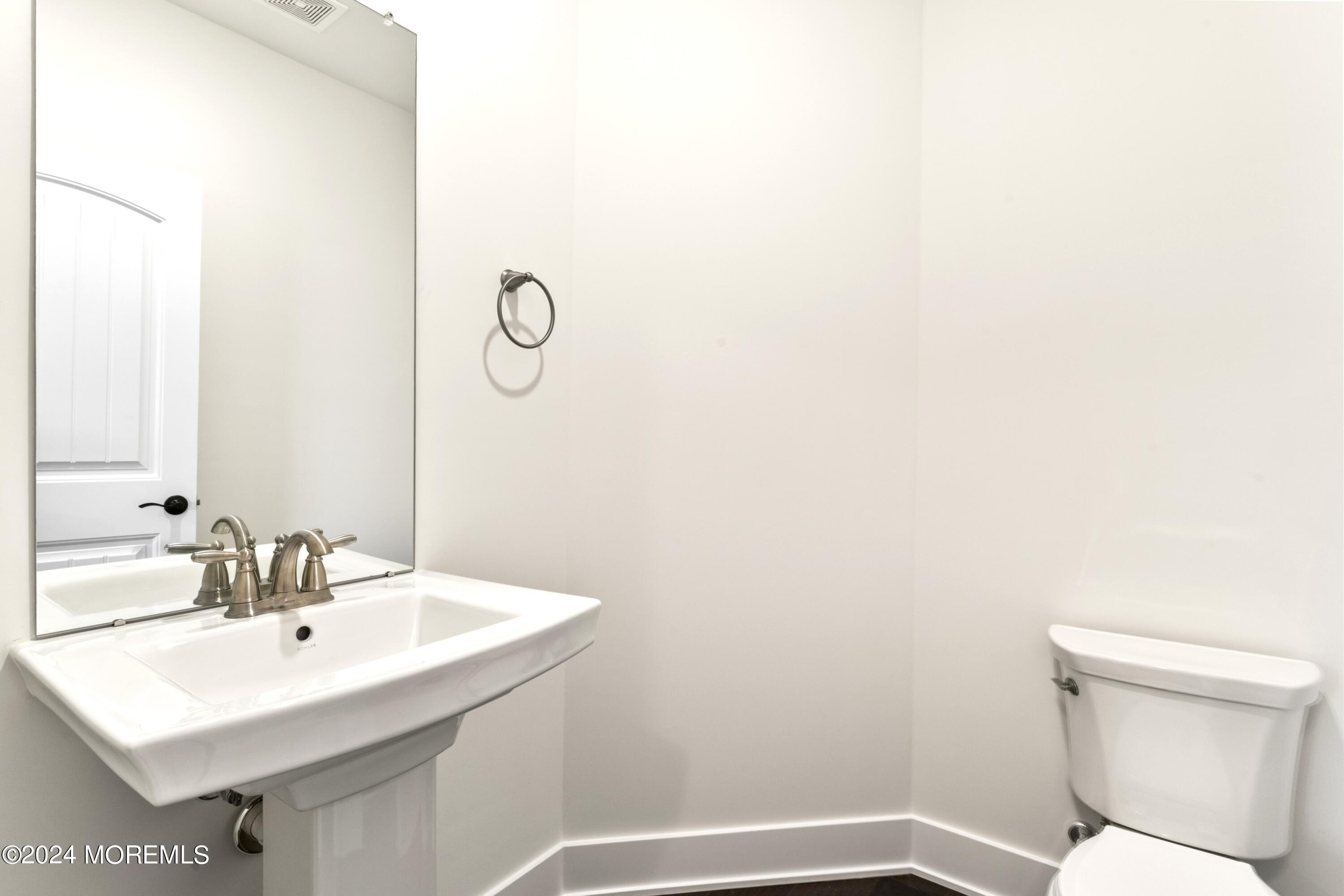 25 Raritan Cove Keyport, NJ 07735 - Photo 19 of 50 a bathroom with a sink toilet and vanity