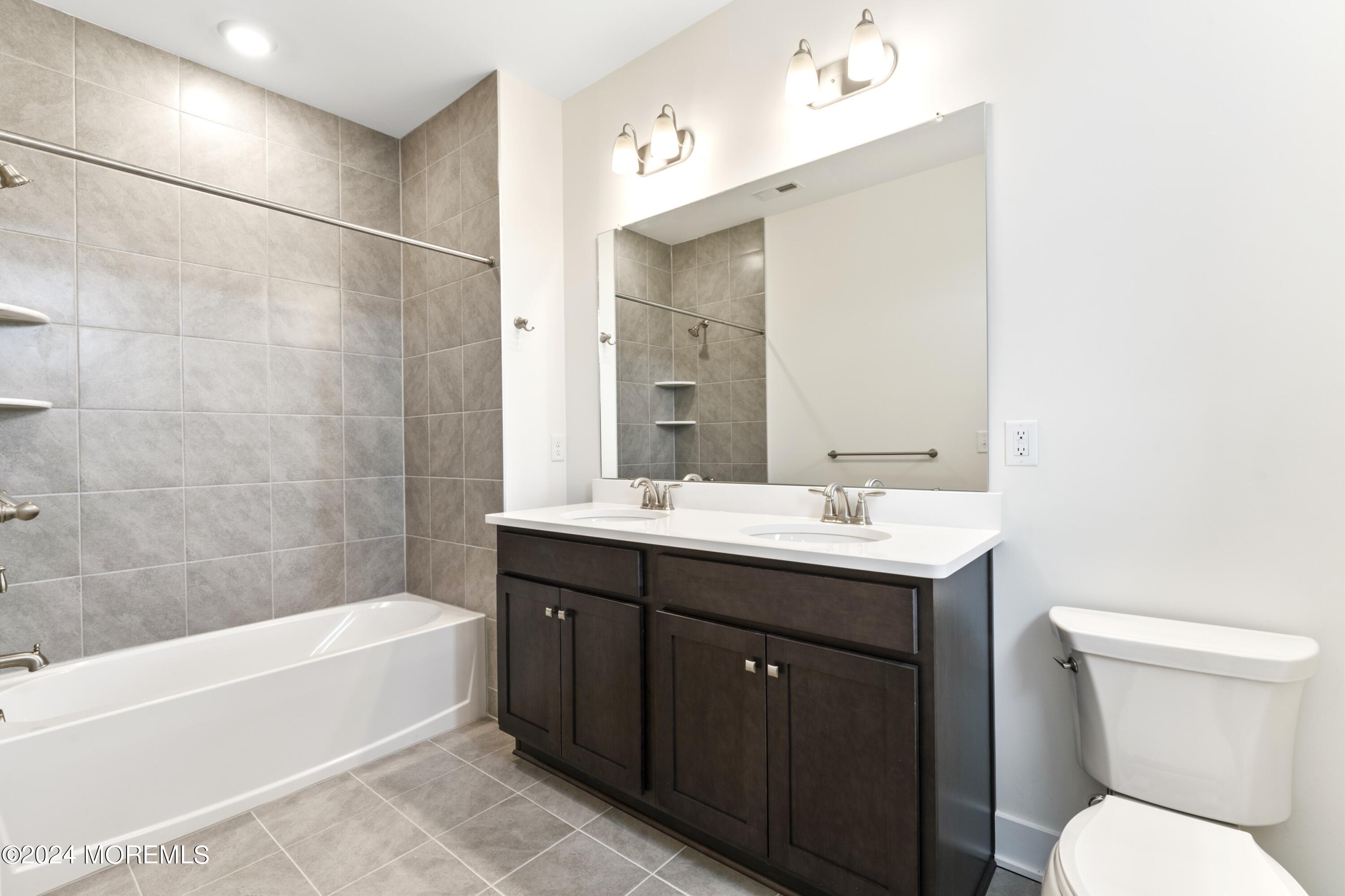 25 Raritan Cove Keyport, NJ 07735 - Photo 29 of 50 a bathroom with a sink a toilet and shower