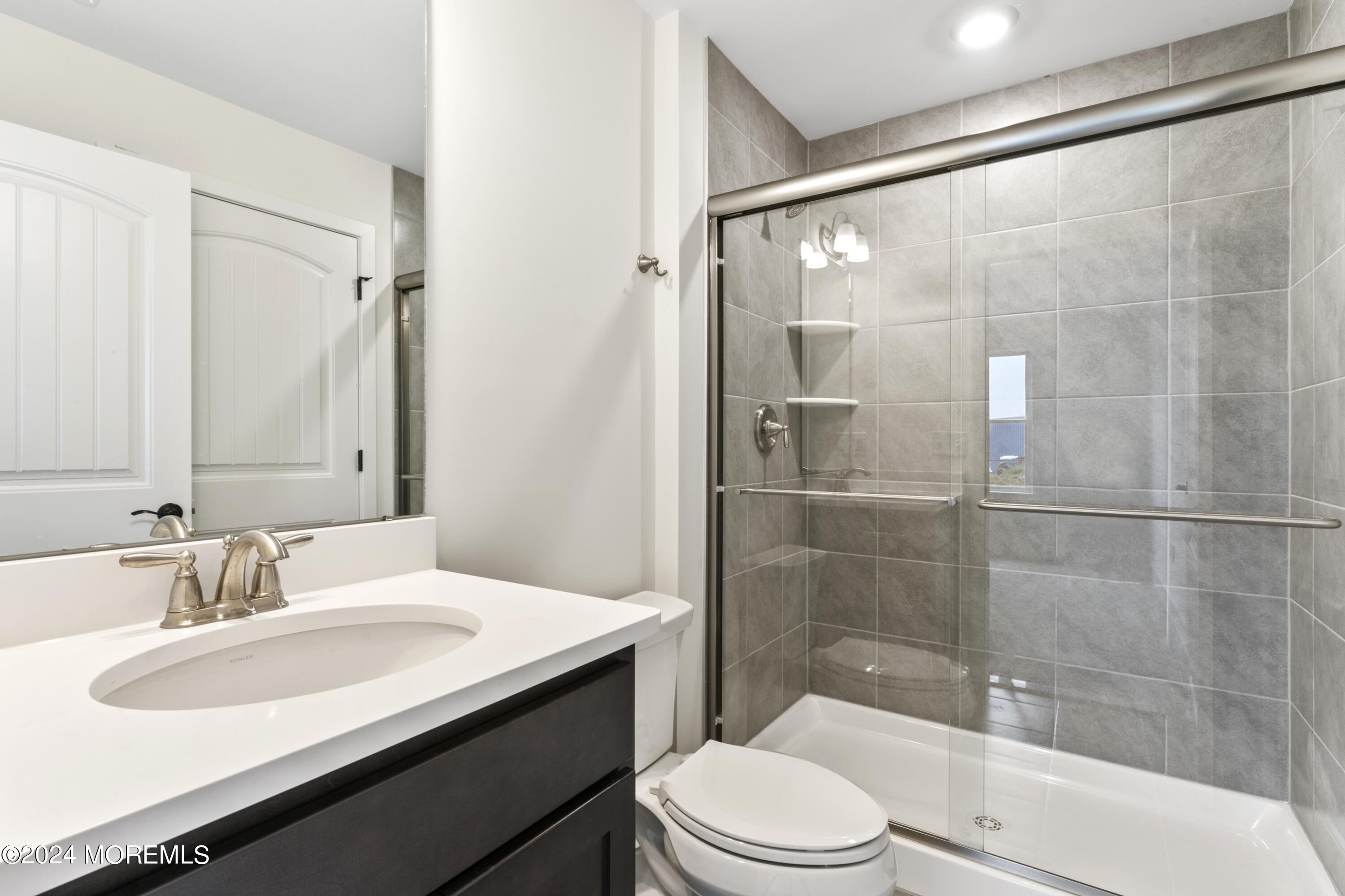 25 Raritan Cove Keyport, NJ 07735 - Photo 9 of 50 a bathroom with a sink a toilet and shower