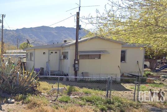 Undisclosed Address Lake Isabella, CA 93240 - Photo 1 of 16 a view of a house with a small yard and sitting area