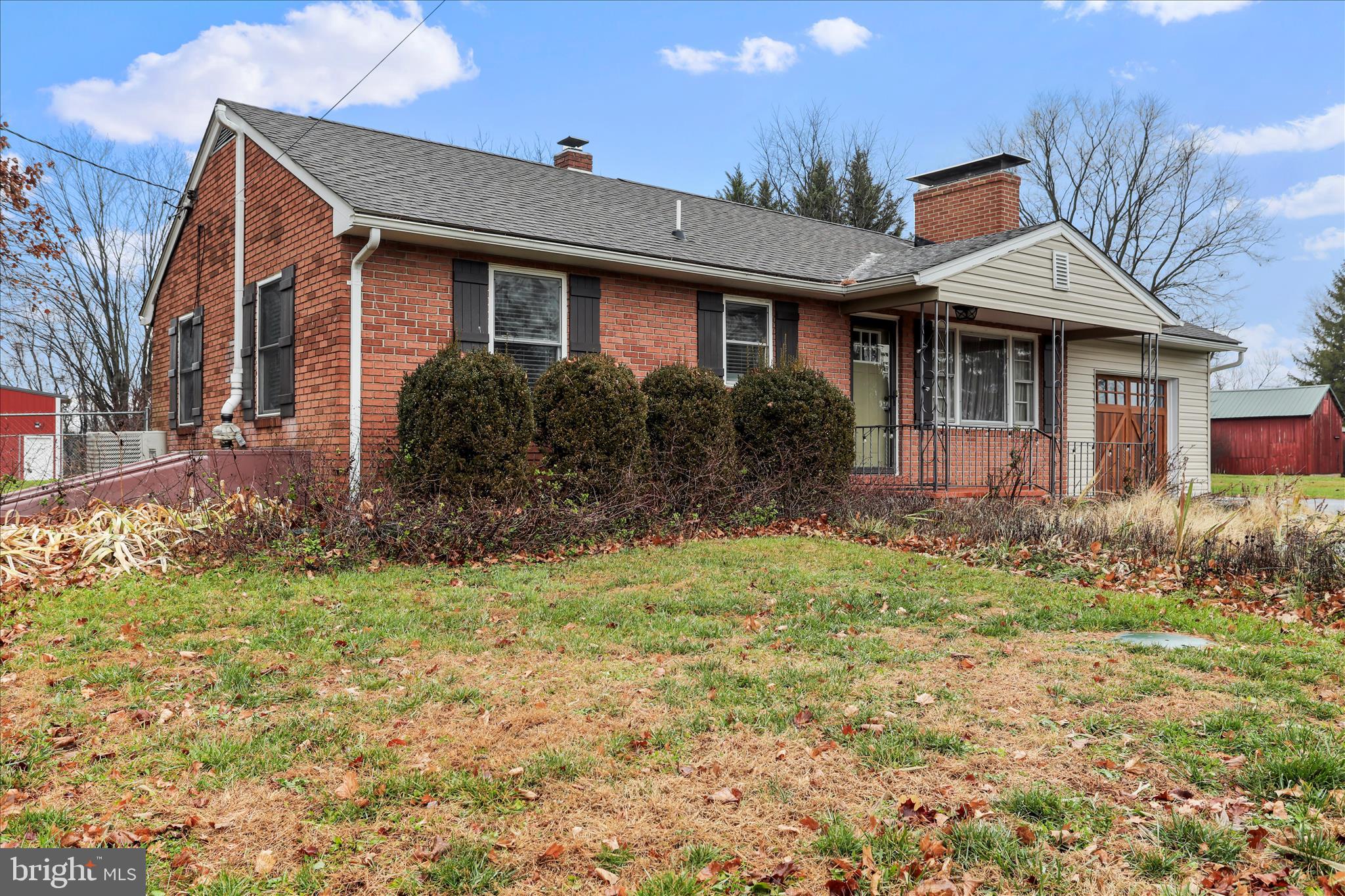 a front view of house with yard and trees around