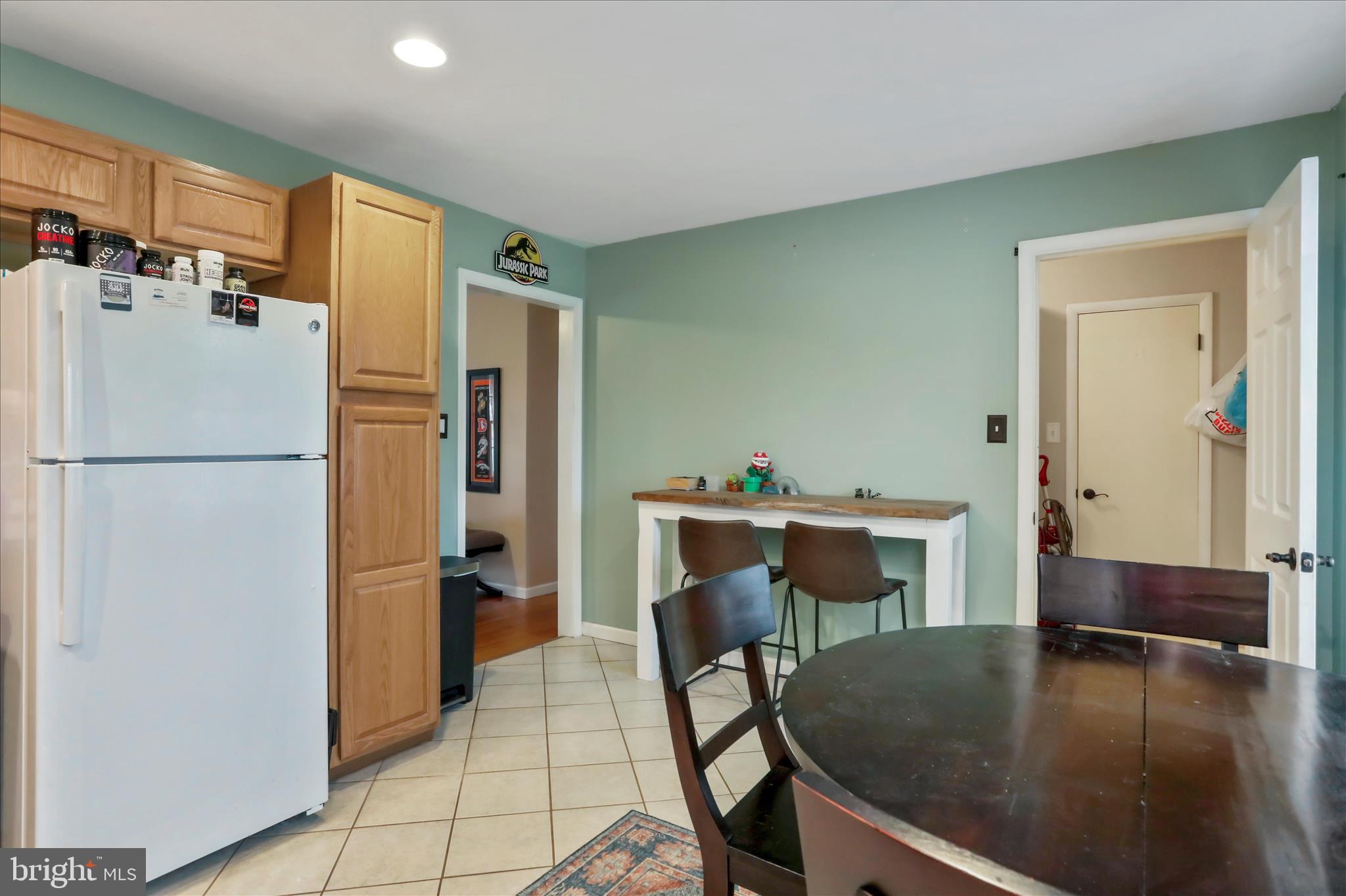 4381 Engle Molers Road Shepherdstown, WV 25443 - Photo 14 of 44 a kitchen with a refrigerator a table and chairs