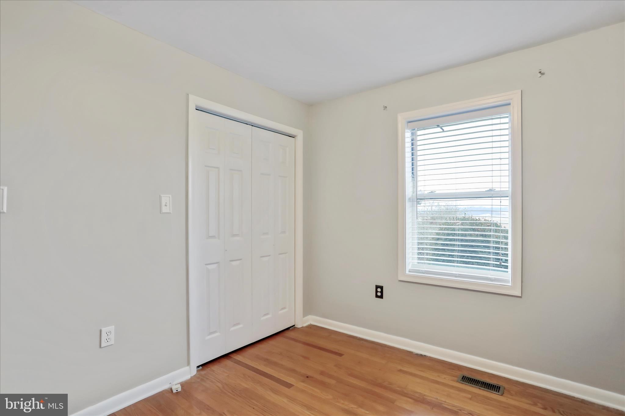 4381 Engle Molers Road Shepherdstown, WV 25443 - Photo 18 of 44 a view of an empty room with wooden floor and a window