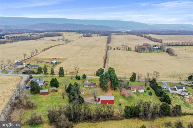 an aerial view of a house with a yard and lake view