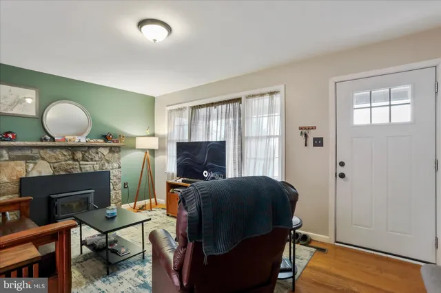 a living room with furniture a flat screen tv and a fireplace