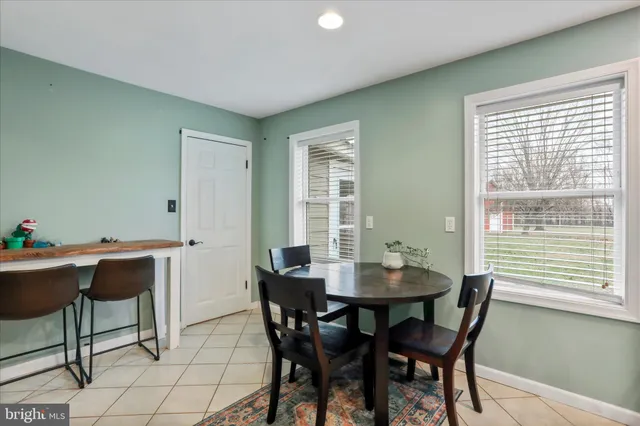 a dining room with furniture and window