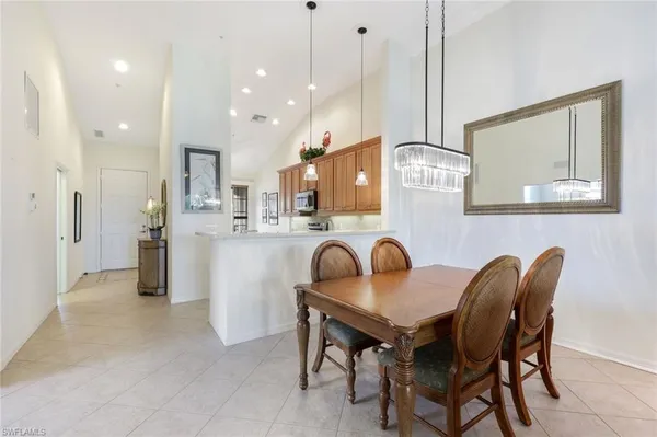 a dining room with furniture and a chandelier