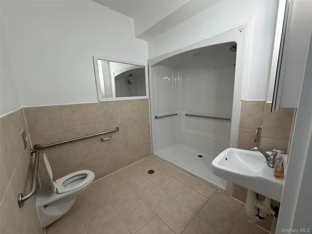 a bathroom with a shower toilet and sink