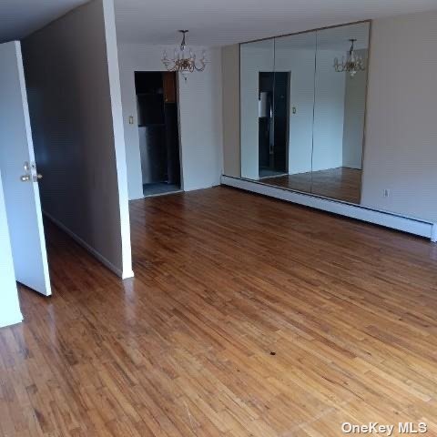 an empty room with wooden floor and closet