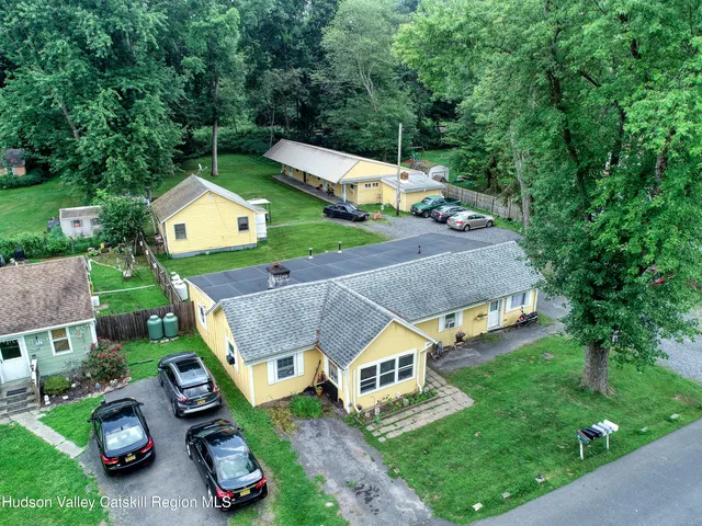an aerial view of a house with garden space and street view