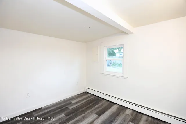 a view of an empty room and wooden floor