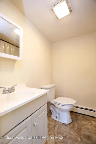 a bathroom with a sink a toilet and mirror