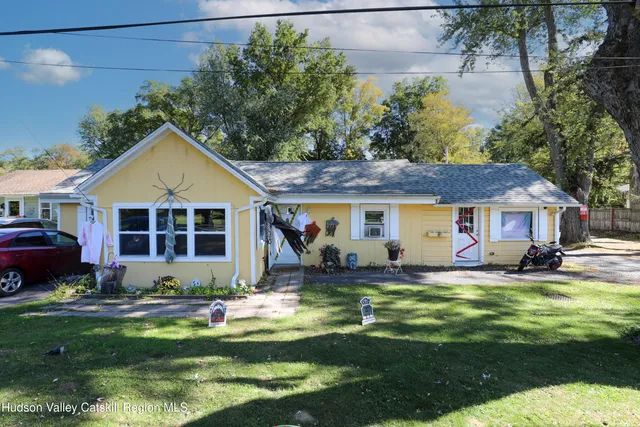 a front view of a house with a yard table and chairs