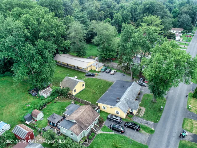 an aerial view of a house with garden space and street view