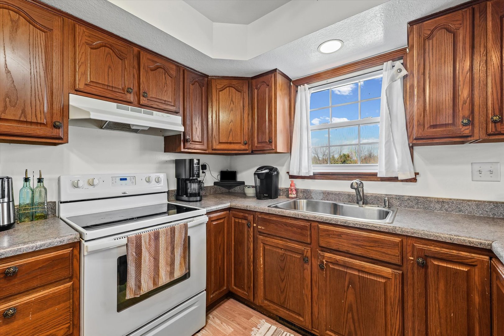 29 Falcon Pass Camargo, IL 61919 - Photo 11 of 27 a kitchen with stainless steel appliances granite countertop a sink stove and cabinets