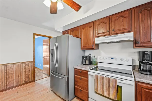 a kitchen with stainless steel appliances granite countertop a refrigerator sink and cabinets