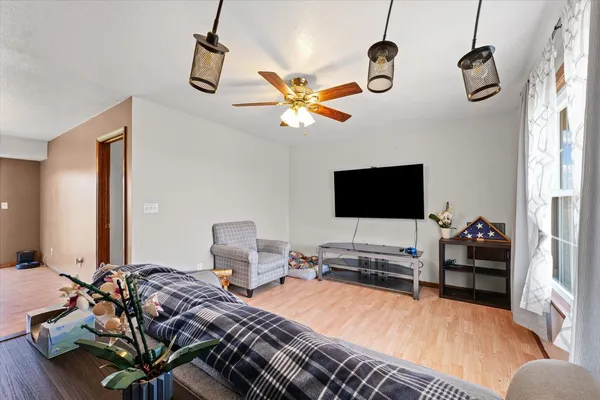 a bedroom with bed and a flat tv screen
