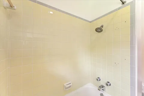 a bathroom with a tub and a shower