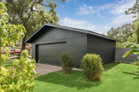 a backyard of a house with plants and entertaining space