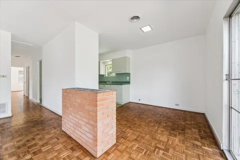 wooden floor in an empty room with a fireplace