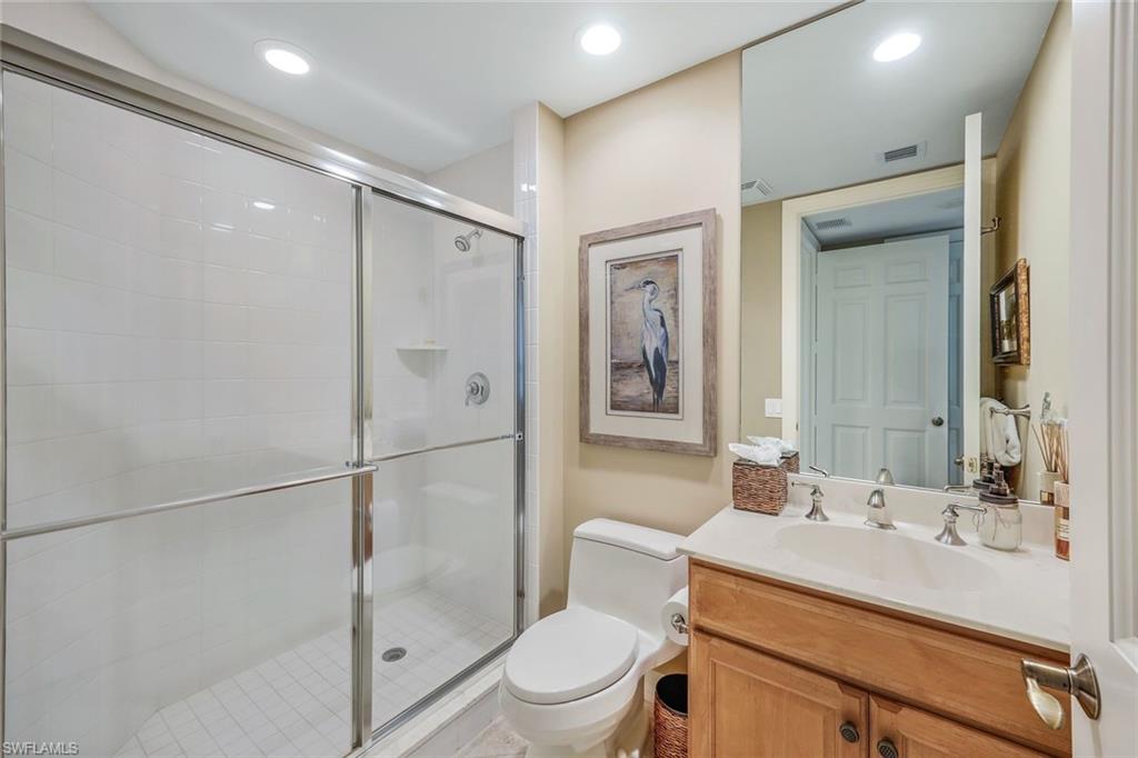 295 Grande Way, Unit 1202 Naples, FL 34110 - Photo 23 of 36 a bathroom with a sink toilet and shower