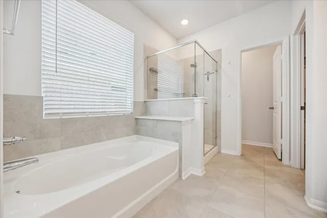 a bathroom with a bathtub and a shower