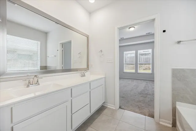 a bathroom with a double vanity sink and a mirror