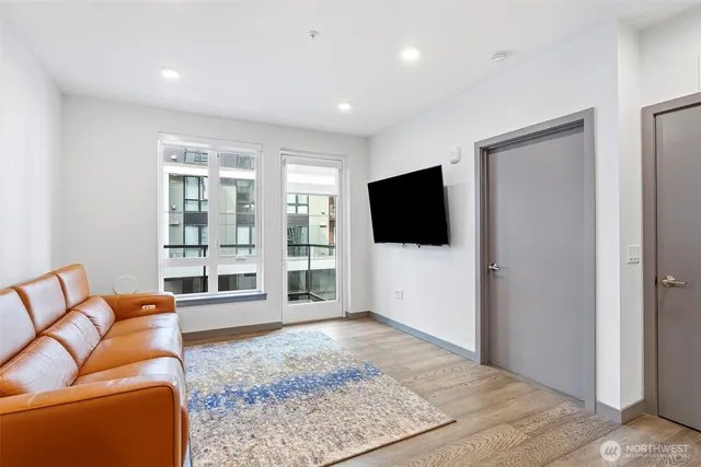 a living room with furniture and kitchen view