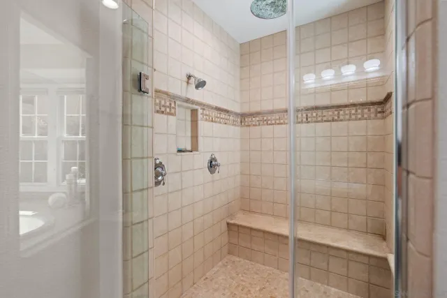 a bathroom with a double vanity sink and a mirror