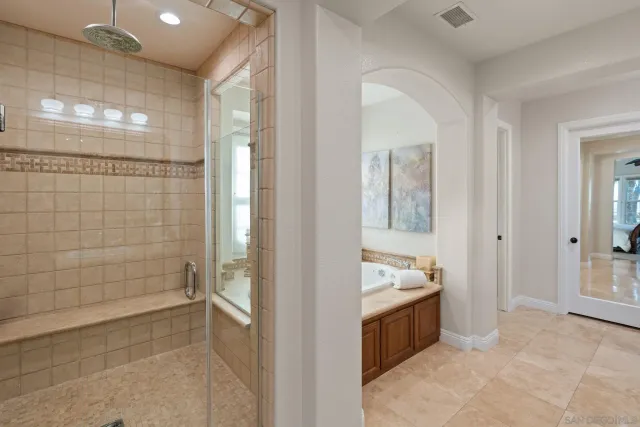 a bathroom with a toilet sink vanity and mirror