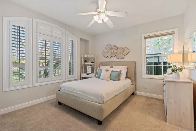 a living room with furniture a window and potted plant