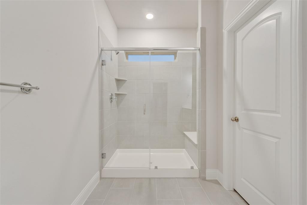 7853 Sunset Boulevard Rowlett, TX 75088 - Photo 9 of 31 a bathroom with a shower and a toilet