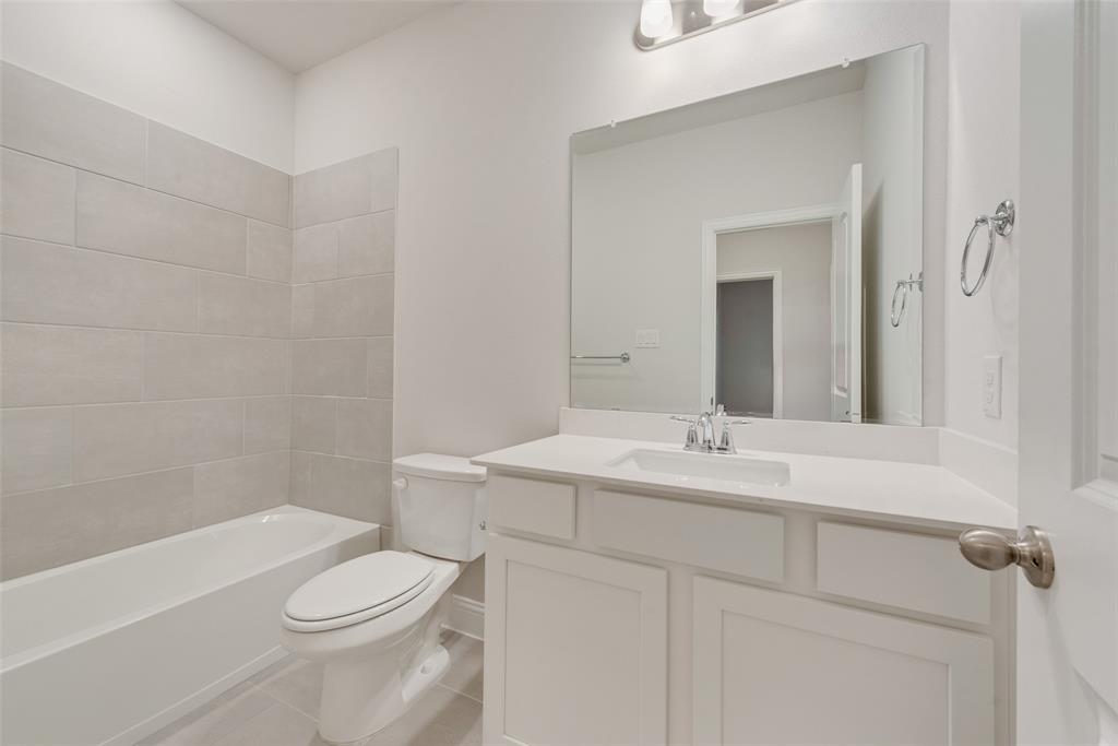 7853 Sunset Boulevard Rowlett, TX 75088 - Photo 16 of 31 a bathroom with a sink a toilet and shower