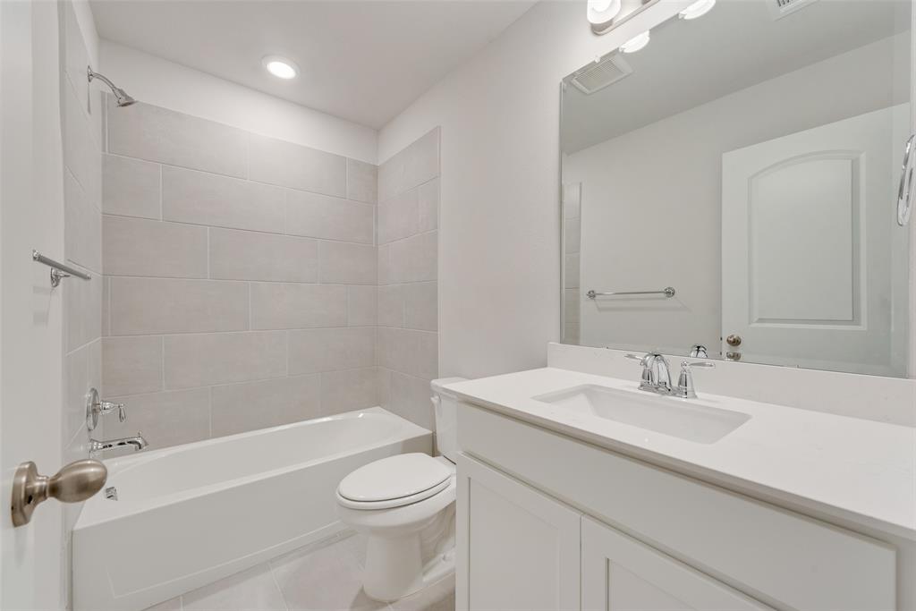 7853 Sunset Boulevard Rowlett, TX 75088 - Photo 23 of 31 a bathroom with a sink a toilet and shower