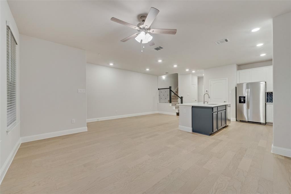 7853 Sunset Boulevard Rowlett, TX 75088 - Photo 7 of 31 a view of a kitchen with a sink and a refrigerator