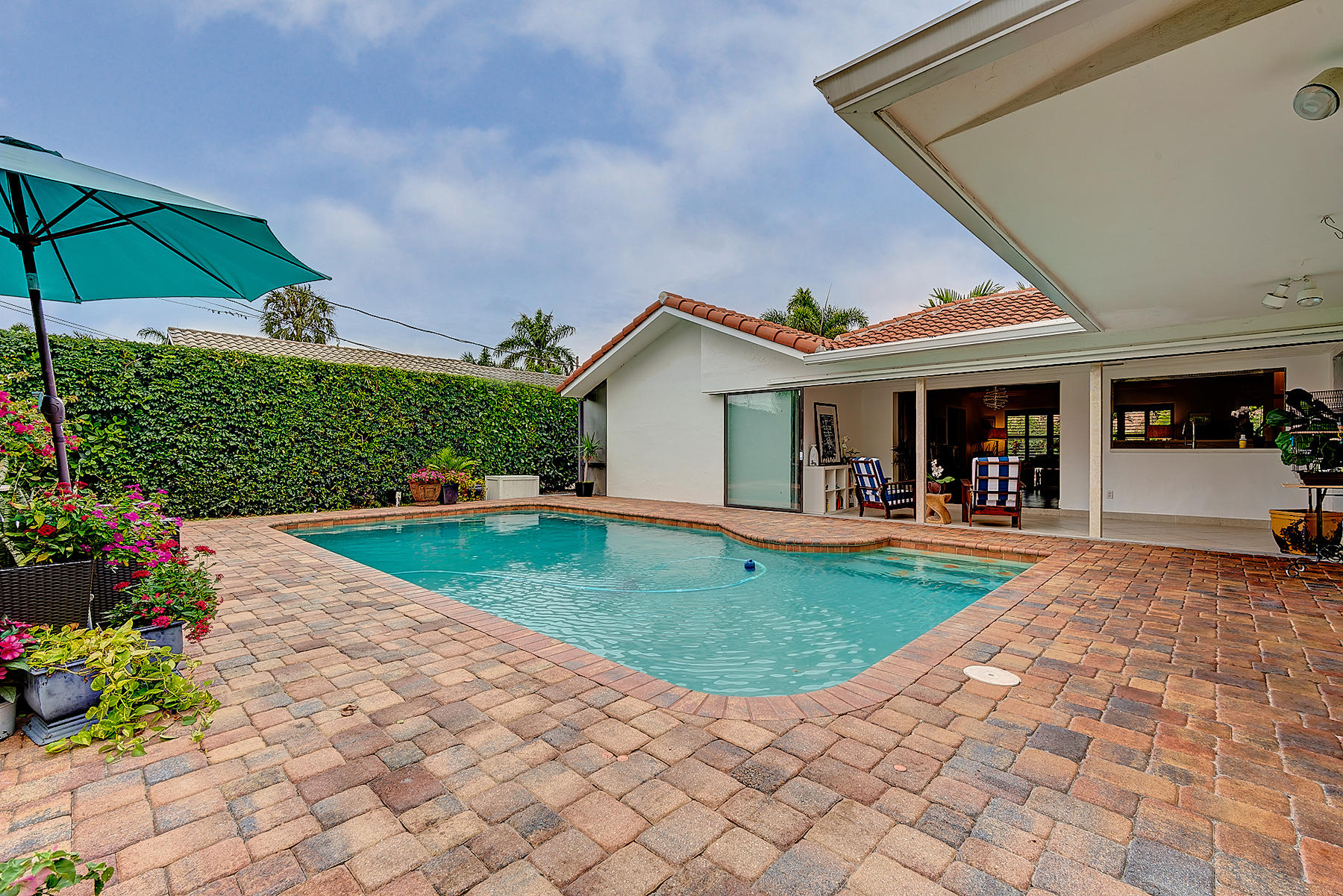 1061 Northwest 6th Street Boca Raton, FL 33486 - Photo 36 of 49 Paver Patio with Open Family Room Doors