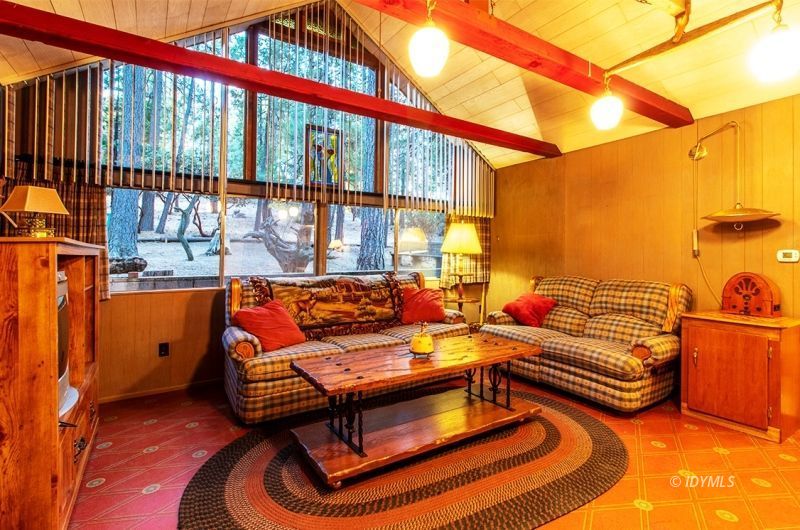 27401 Saunders Meadow Road Idyllwild, CA 92549 - Photo 16 of 37 a outdoor living room with furniture and a floor to ceiling window