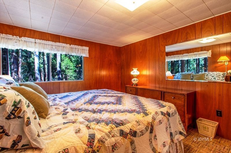 27401 Saunders Meadow Road Idyllwild, CA 92549 - Photo 18 of 37 a bedroom with a bed and a large window