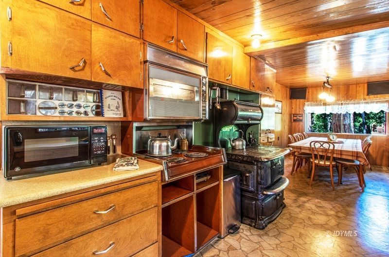 27401 Saunders Meadow Road Idyllwild, CA 92549 - Photo 21 of 37 a view of a patio with table and chairs a barbeque