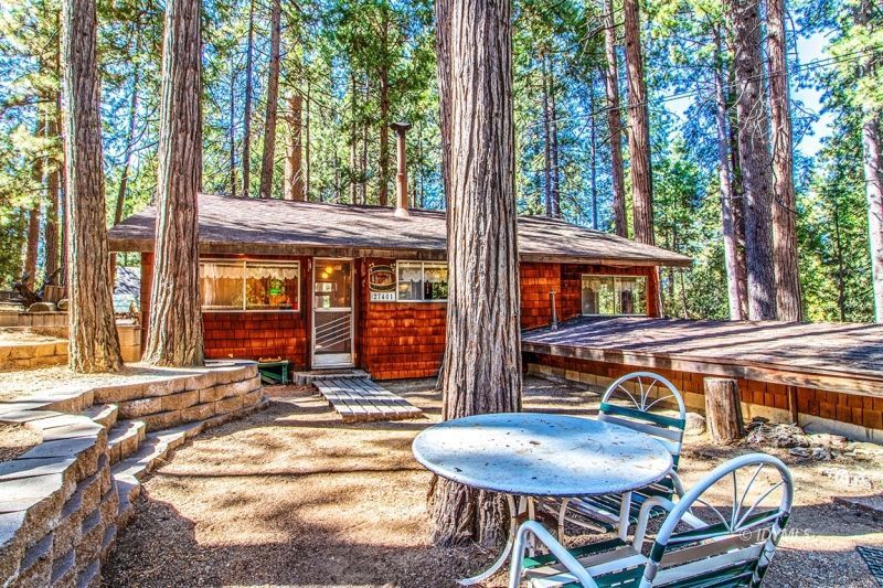 27401 Saunders Meadow Road Idyllwild, CA 92549 - Photo 32 of 37 a view of a patio with table and chairs with wooden floor and fence