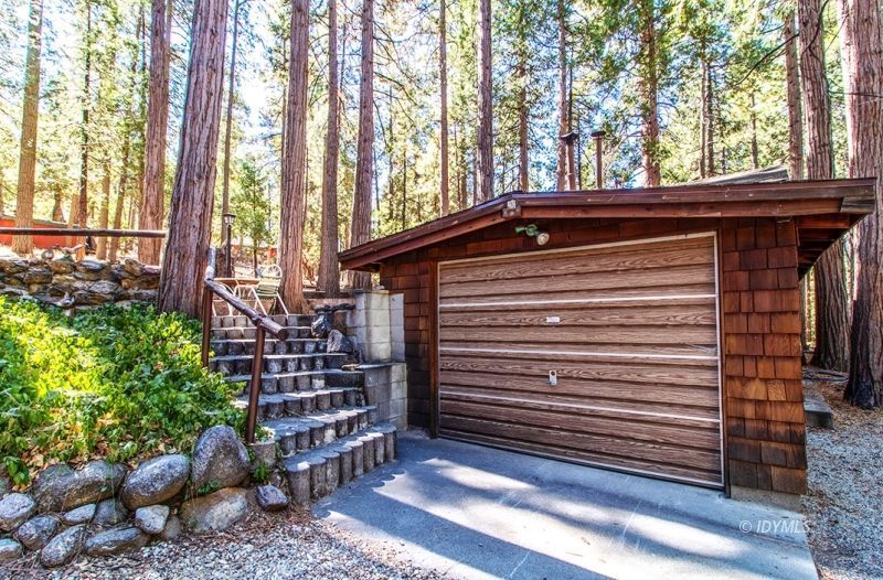27401 Saunders Meadow Road Idyllwild, CA 92549 - Photo 5 of 37 a view of a house with a large window and wooden fence