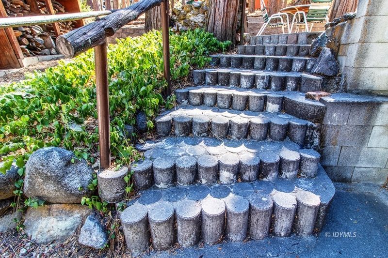 27401 Saunders Meadow Road Idyllwild, CA 92549 - Photo 6 of 37 a view of a chairs and table in backyard