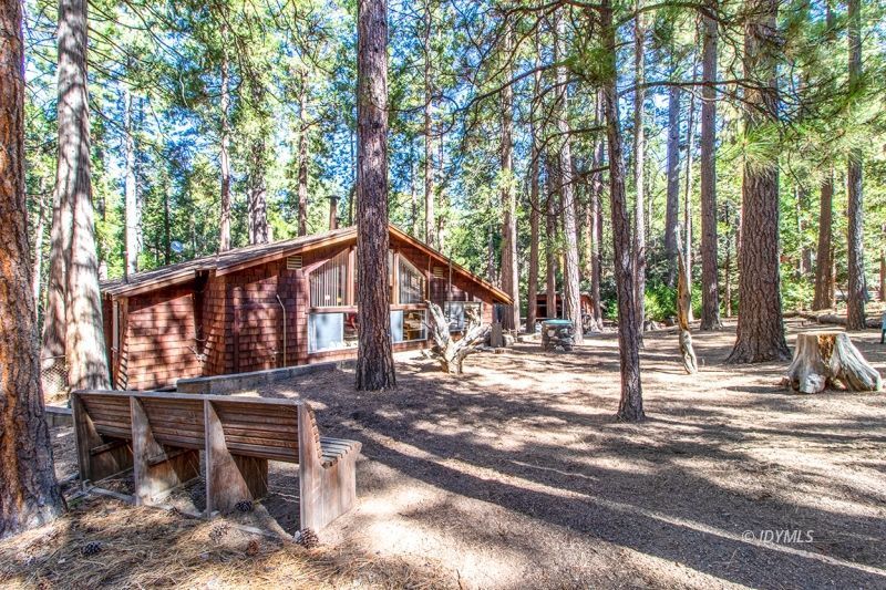 27401 Saunders Meadow Road Idyllwild, CA 92549 - Photo 10 of 37 a view of a house with large trees and wooden fence