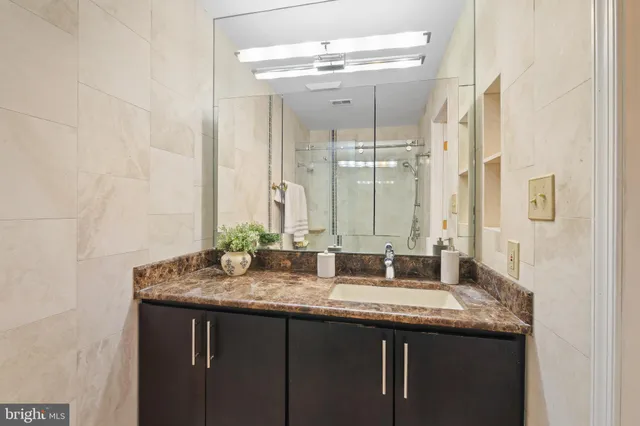 a bathroom with double sink and a mirror