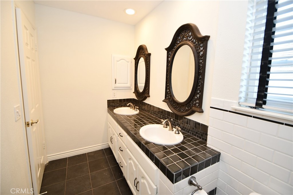 2123 Shelburne Way, Unit 29 Torrance, CA 90503 - Photo 28 of 41 a bathroom with a sink and a mirror