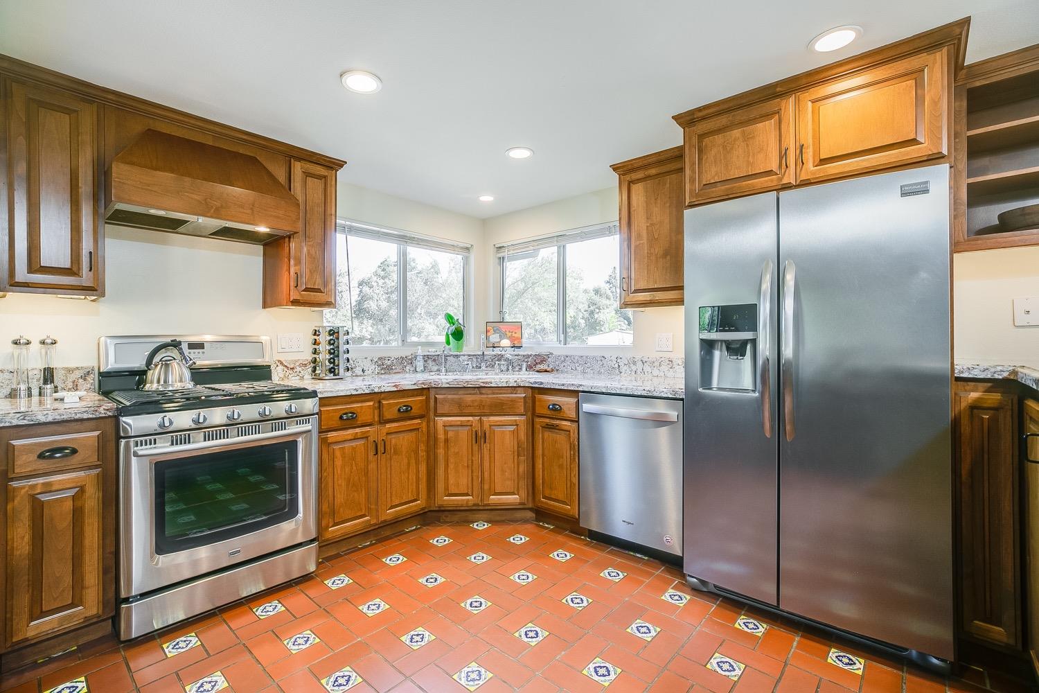 804 Daly Road Ojai, CA 93023 - Photo 11 of 38 a kitchen with stainless steel appliances granite countertop a stove a sink and a refrigerator
